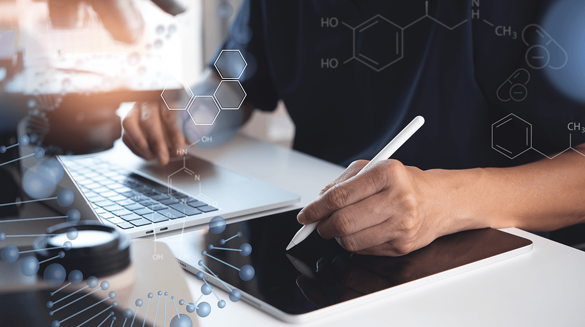 Researcher using a laptop and ipad